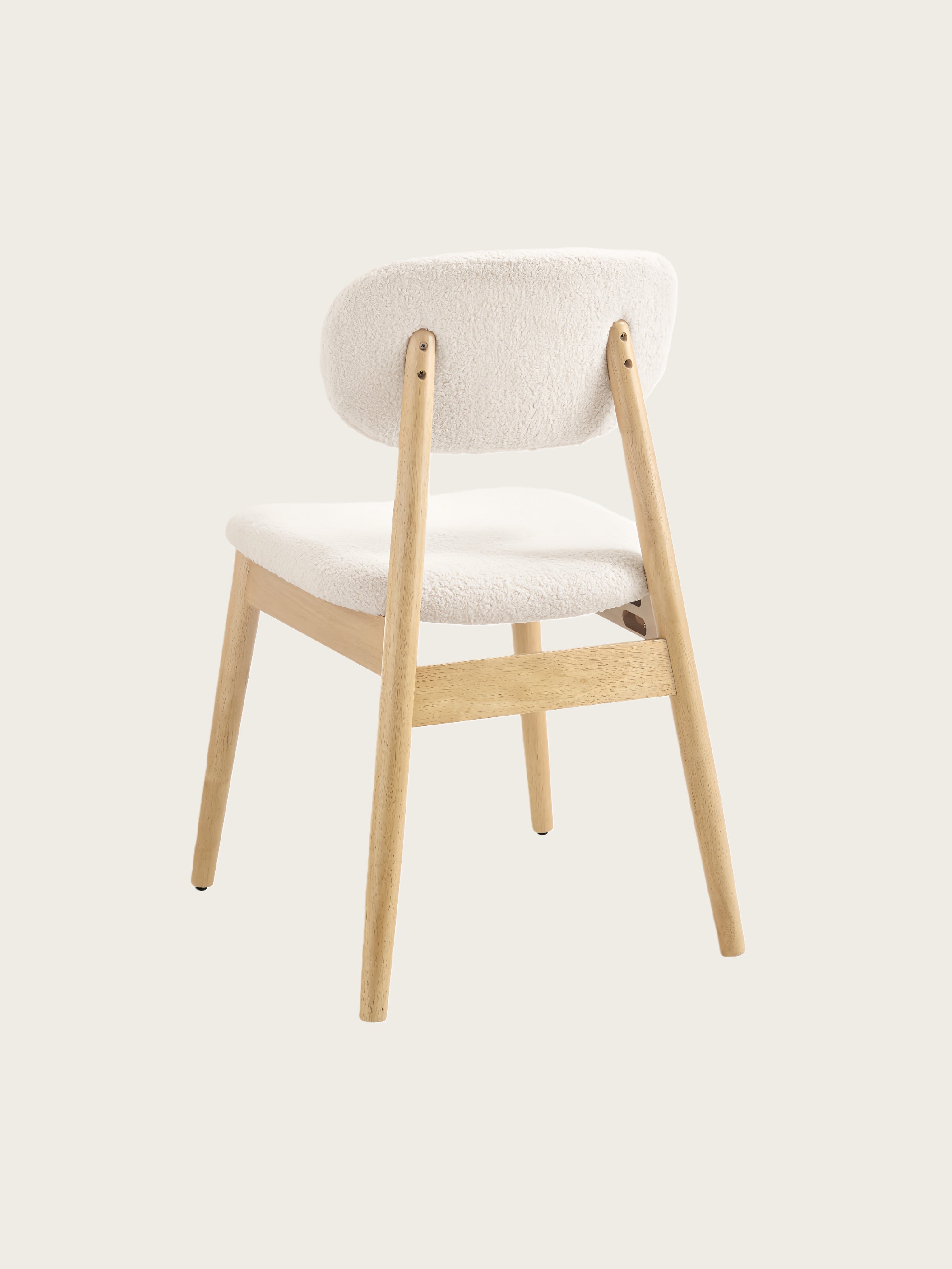 Angled back view of Xdeco Del Mar dining chair with teddy boucle upholstery and solid rubberwood frame