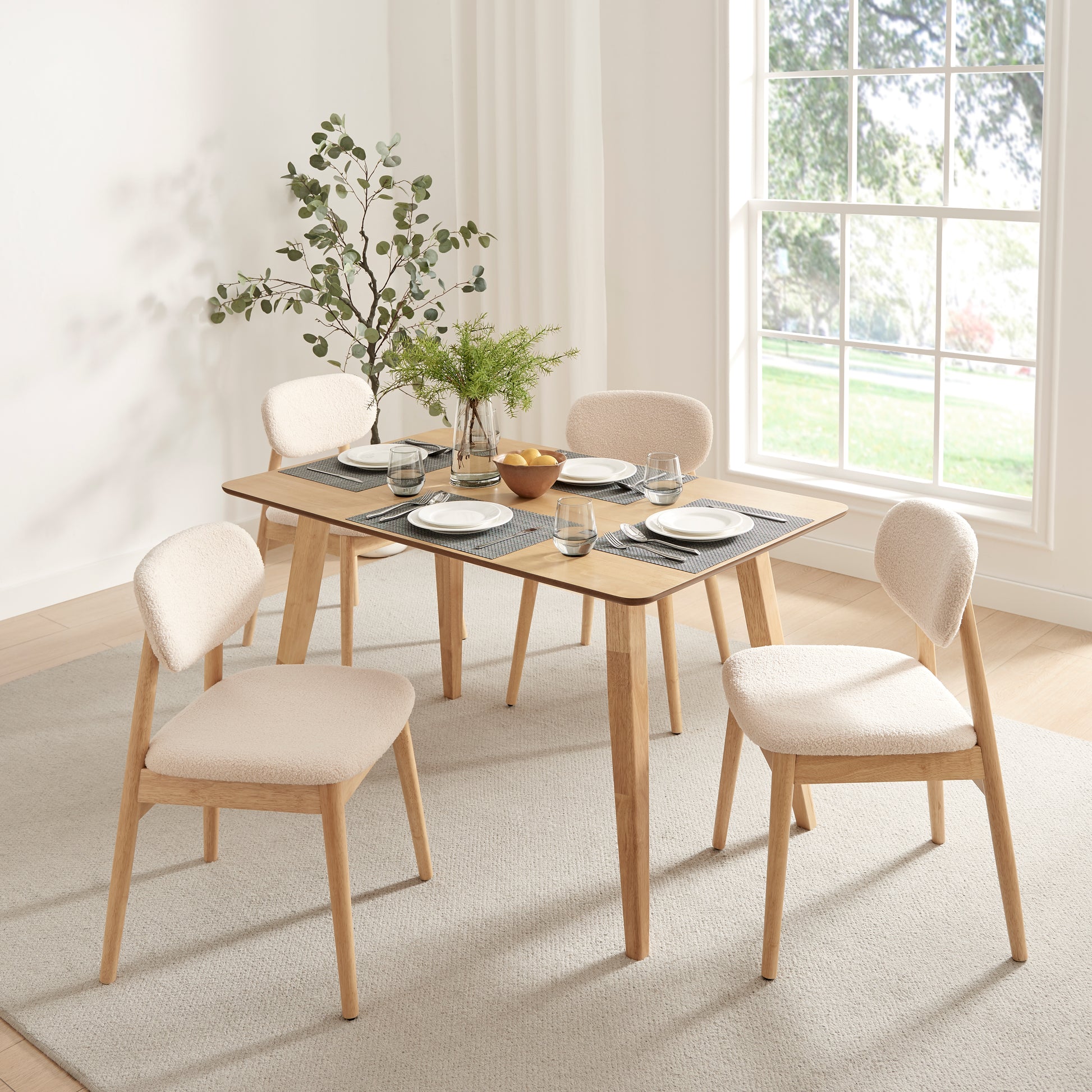 Xdeco Del Mar teddy boucle dining chairs paired with the Escondido wood indoor dining table in a bright modern dining room